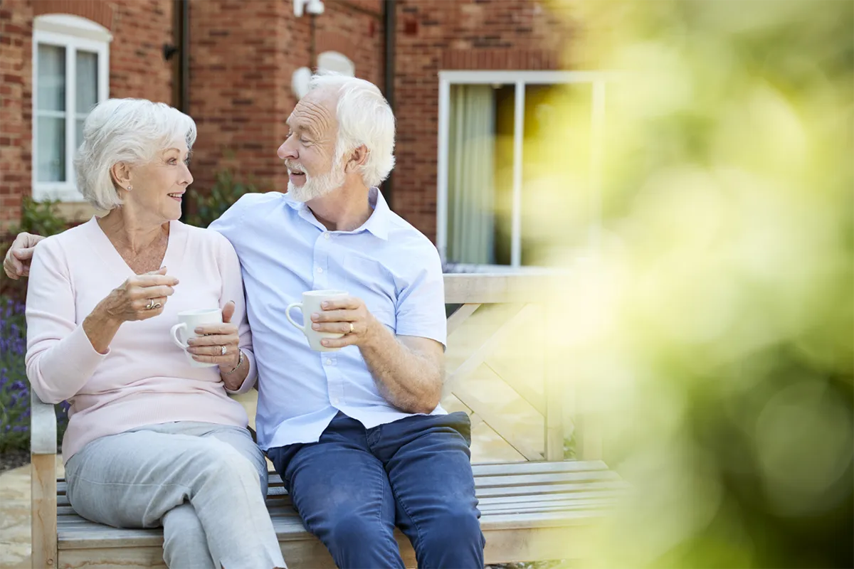 A couple relaxing together outdoors with coffee