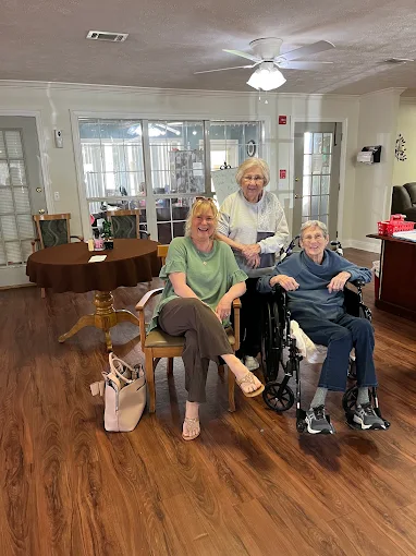 A family visiting with their loved ones in a senior living community common room