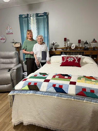 A family helping their loved one settle into their new room